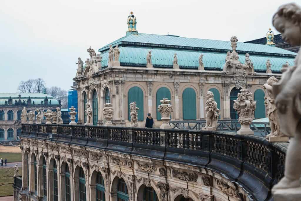 An ornate building with statues on the balcony, perfect for immersing yourself in German culture and language while you learn German online.